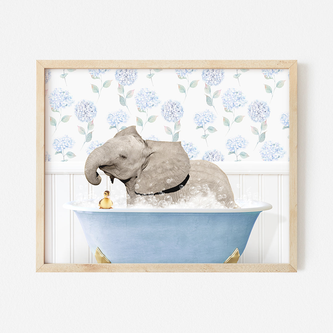 an elephant taking a bath in a blue bathtub