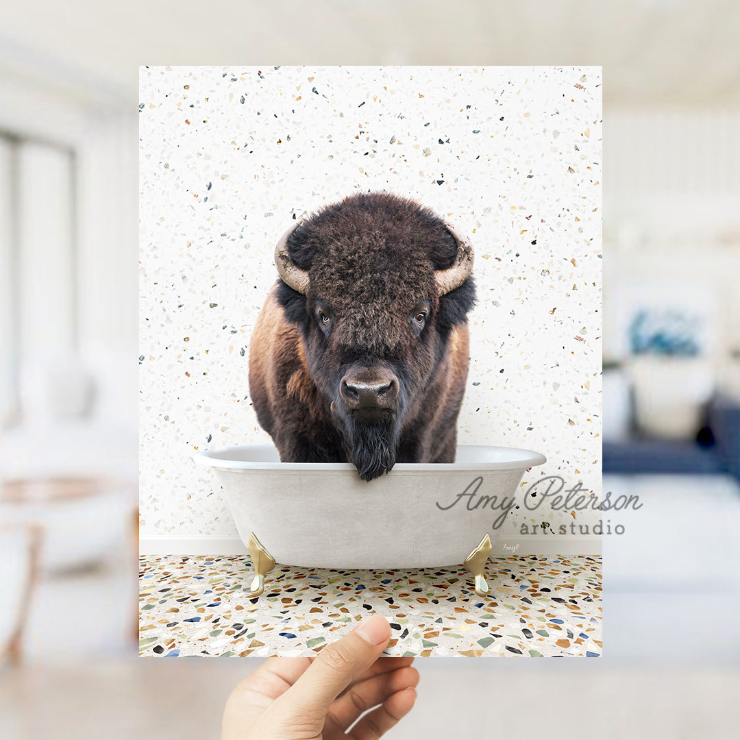 a hand holding up a card with a picture of a bison in a bathtub