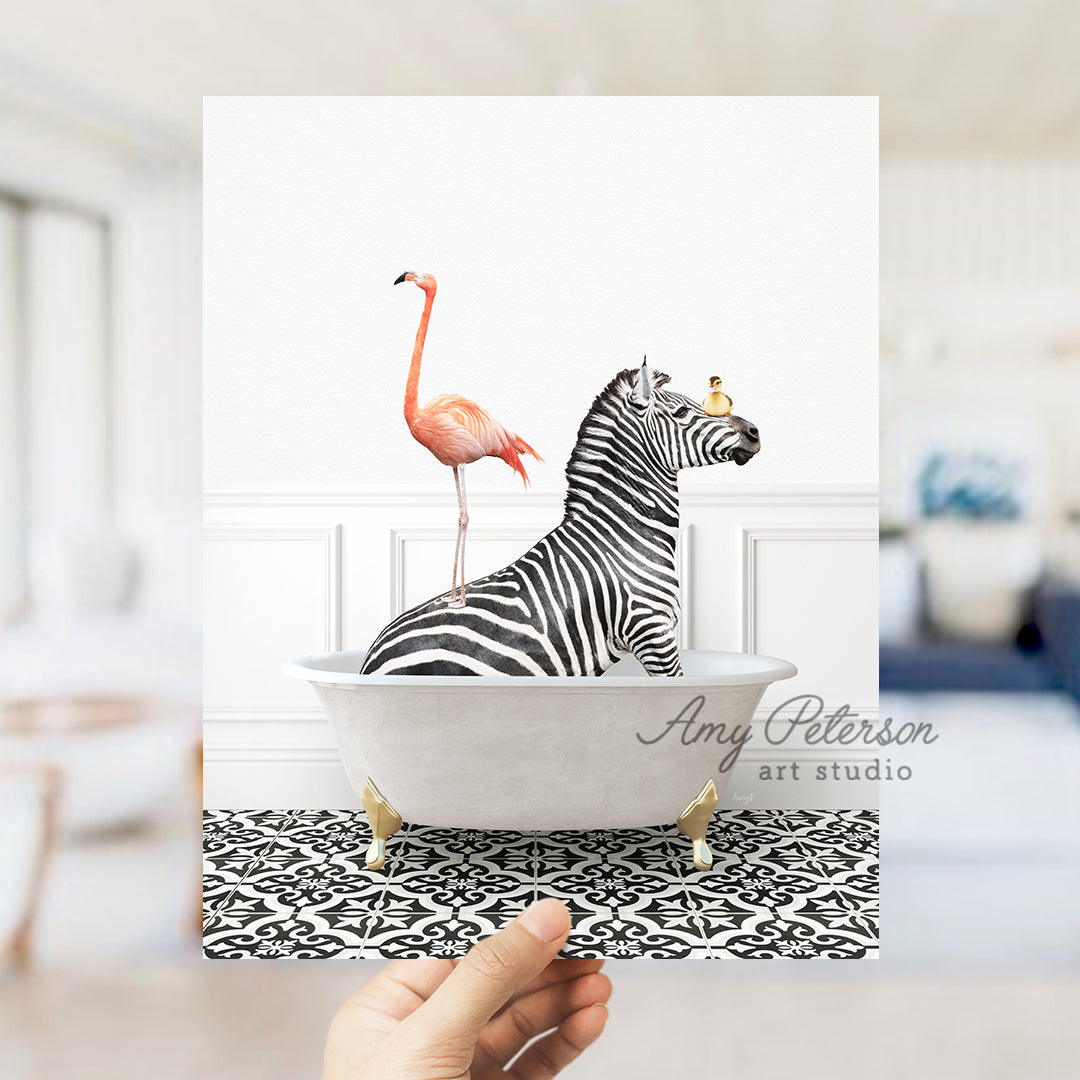 a hand holding a card with a zebra and a flamingo in a bathtub