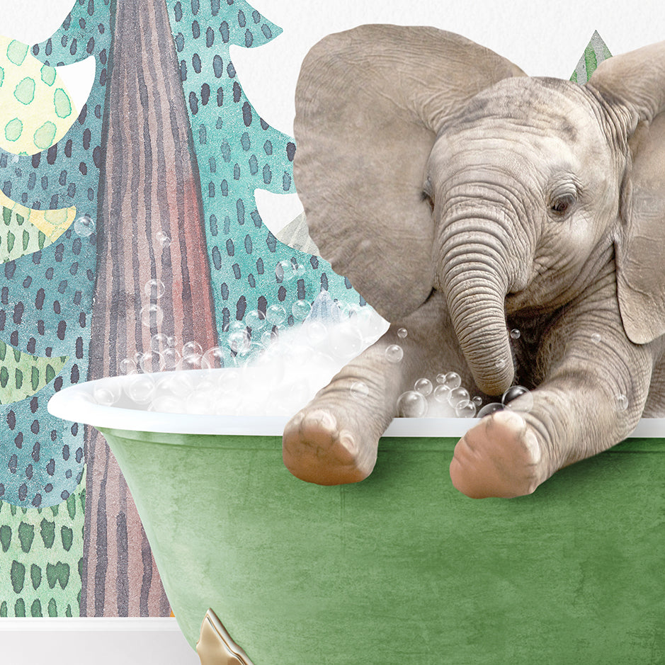 a baby elephant taking a bath in a green tub