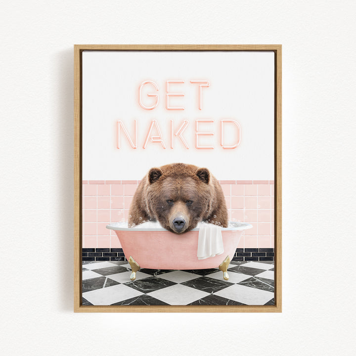 A framed image depicting a brown bear sitting in a pink bathtub, with the text "GET NAKED" displayed above it.
