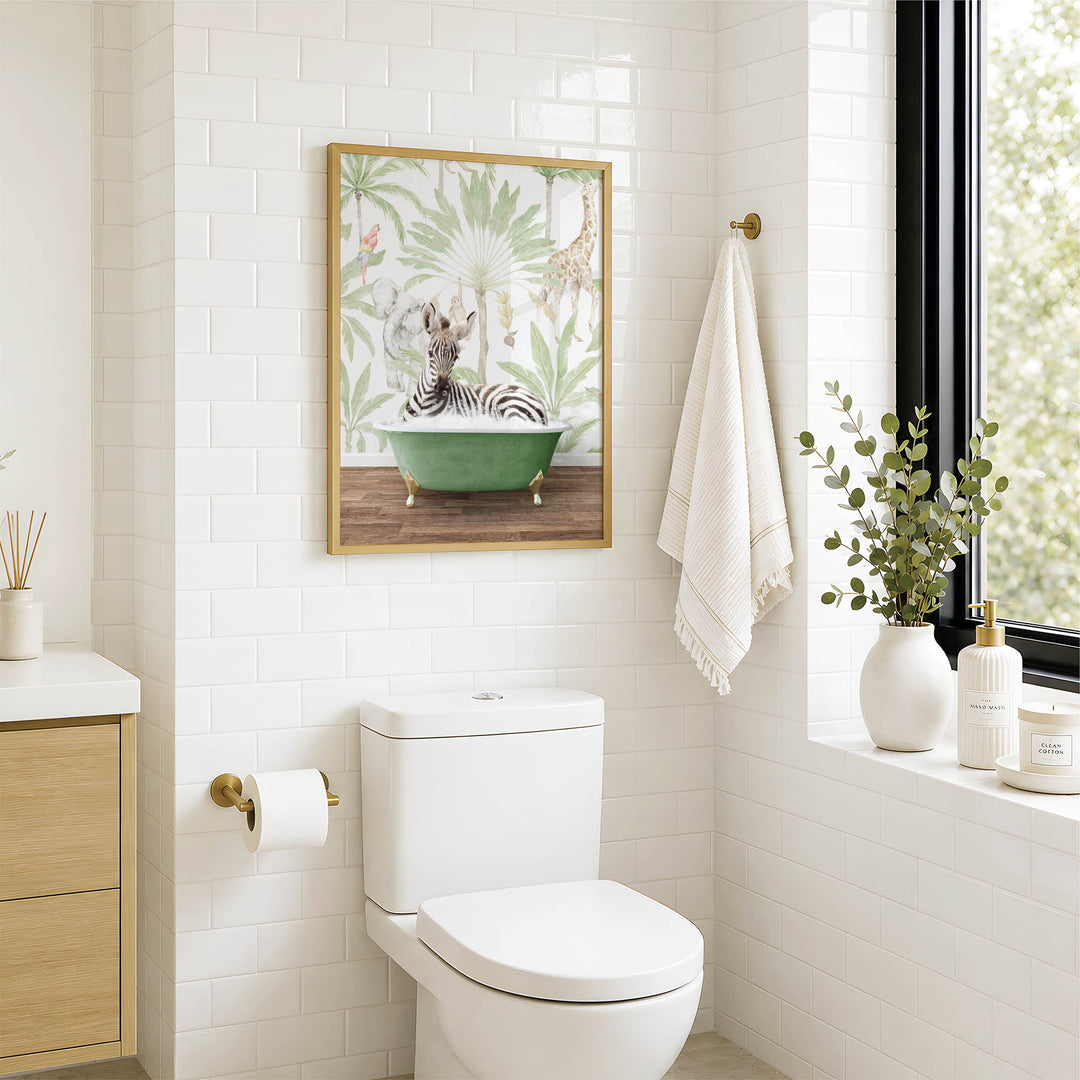 A bathroom with a white toilet, a framed picture of a zebra in a bathtub, and a window with greenery on the sill.