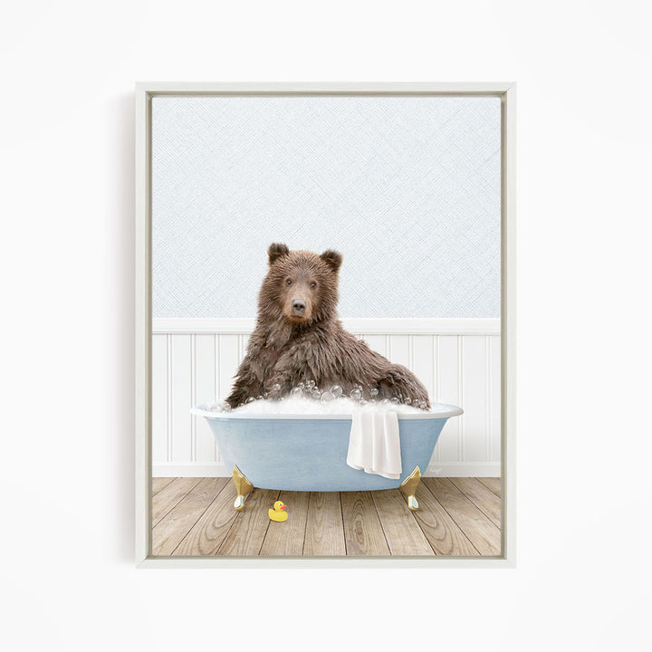 A brown bear sitting in a blue bathtub filled with water, surrounded by rubber duckies.