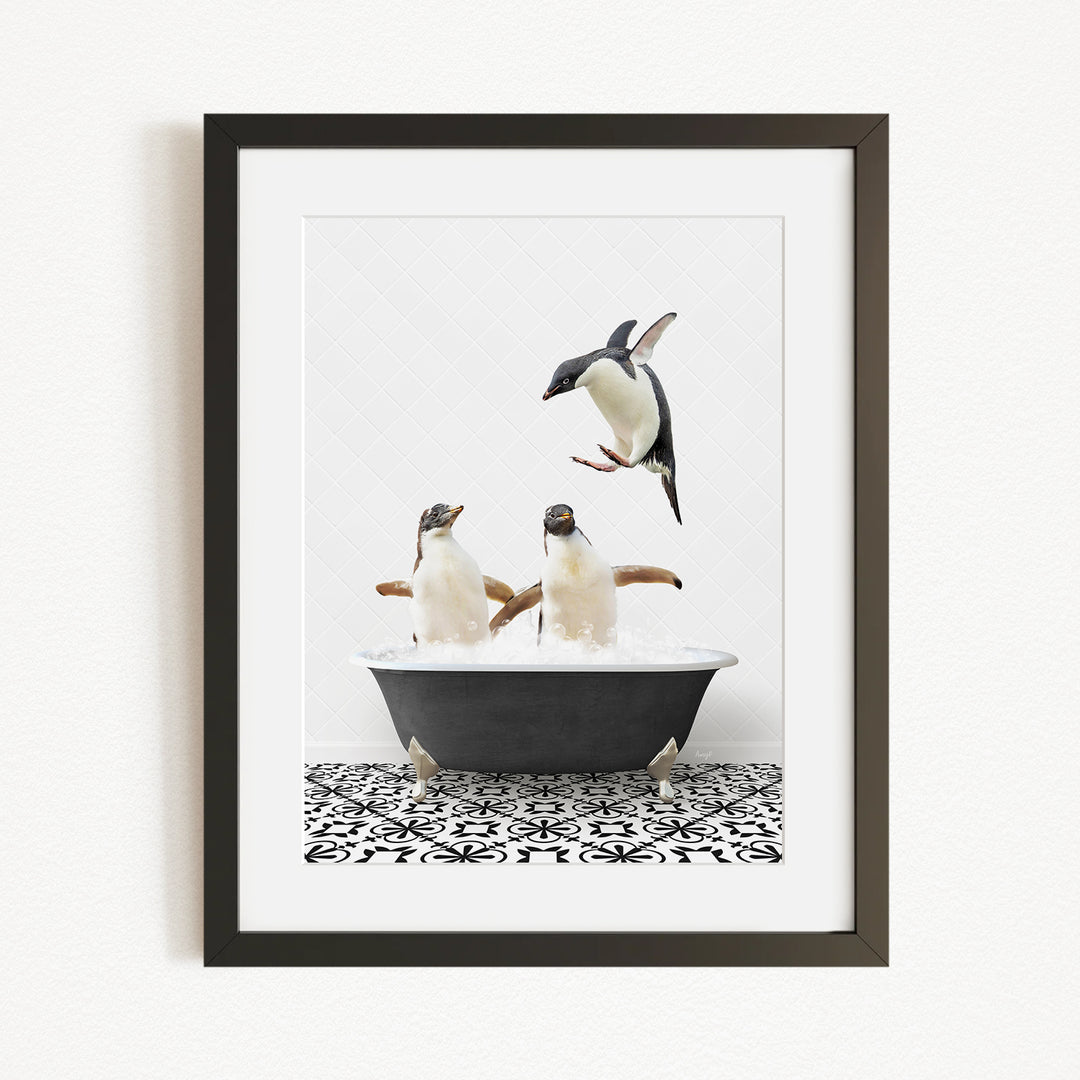 A framed image depicting two penguins sitting in a bathtub, with one penguin flying towards the other.