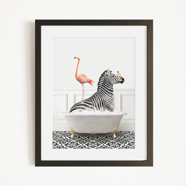 A framed image depicting a zebra sitting in a bathtub, with a flamingo standing on its back and a bird perched on its head.