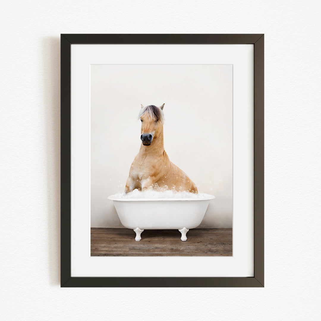 A brown horse sitting in a white bathtub filled with water, creating a whimsical and playful scene.