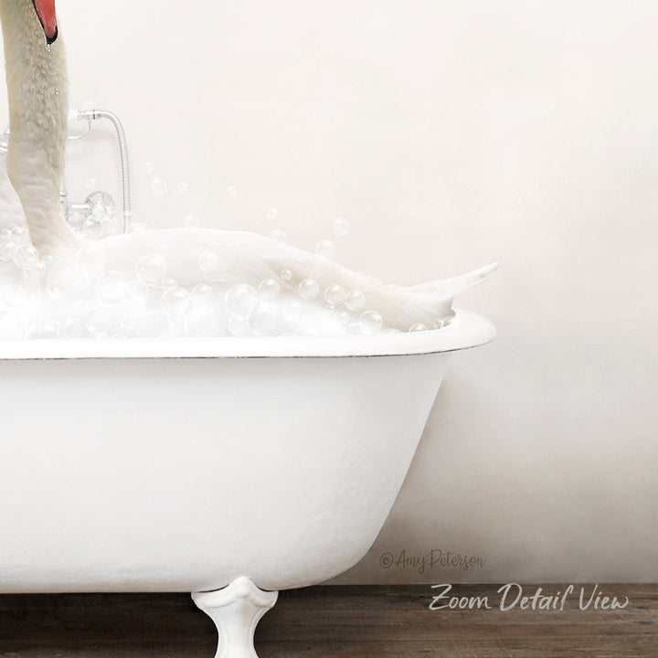 A white bathtub filled with bubbles, with a swan's head submerged in the water.