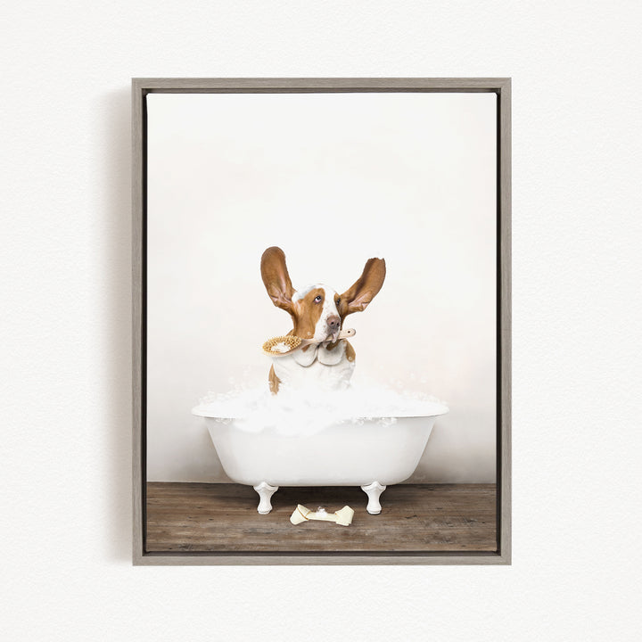 A dog sitting in a white bathtub filled with bubbles, looking directly at the camera with its ears perked up.