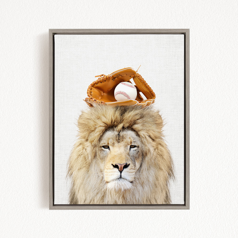 A lion wearing a baseball glove on its head, with a baseball resting on top of the glove.