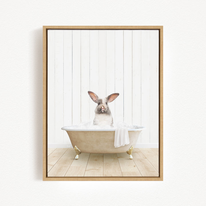 A white rabbit sitting in a bathtub filled with bubbles, with its head poking out of the tub.