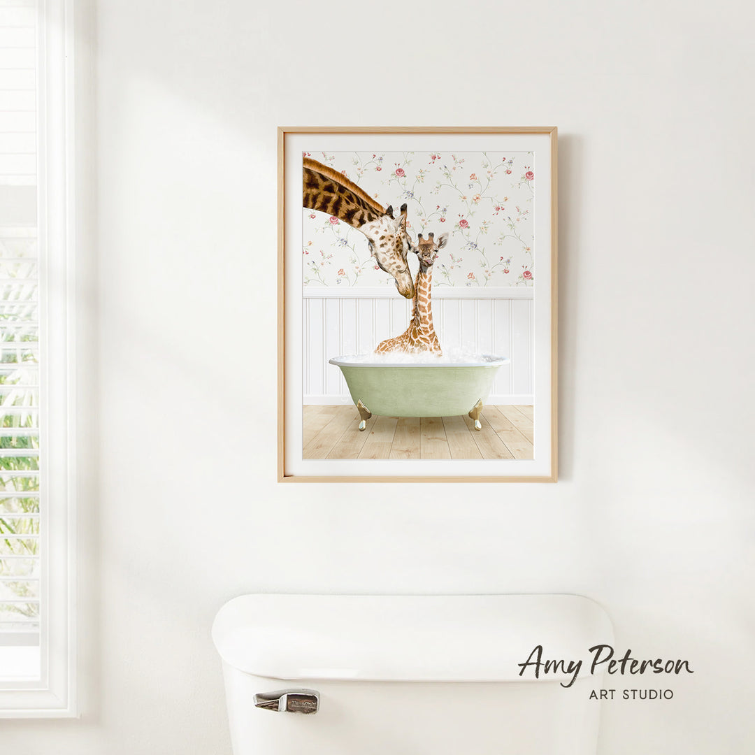 A framed image of two giraffes sitting in a green bathtub, with one giraffe extending its neck towards the other.