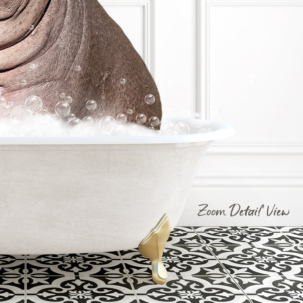 A white bathtub filled with bubbles, with a gold-colored bathtub leg visible, set against a white wall with a black and white patterned tile floor.