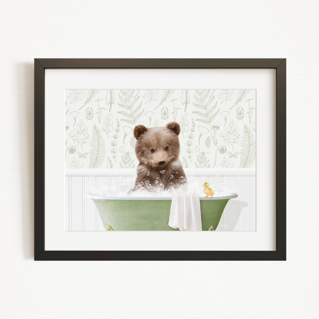 A cute brown bear sitting in a green bathtub, surrounded by a white towel and a yellow rubber duck.