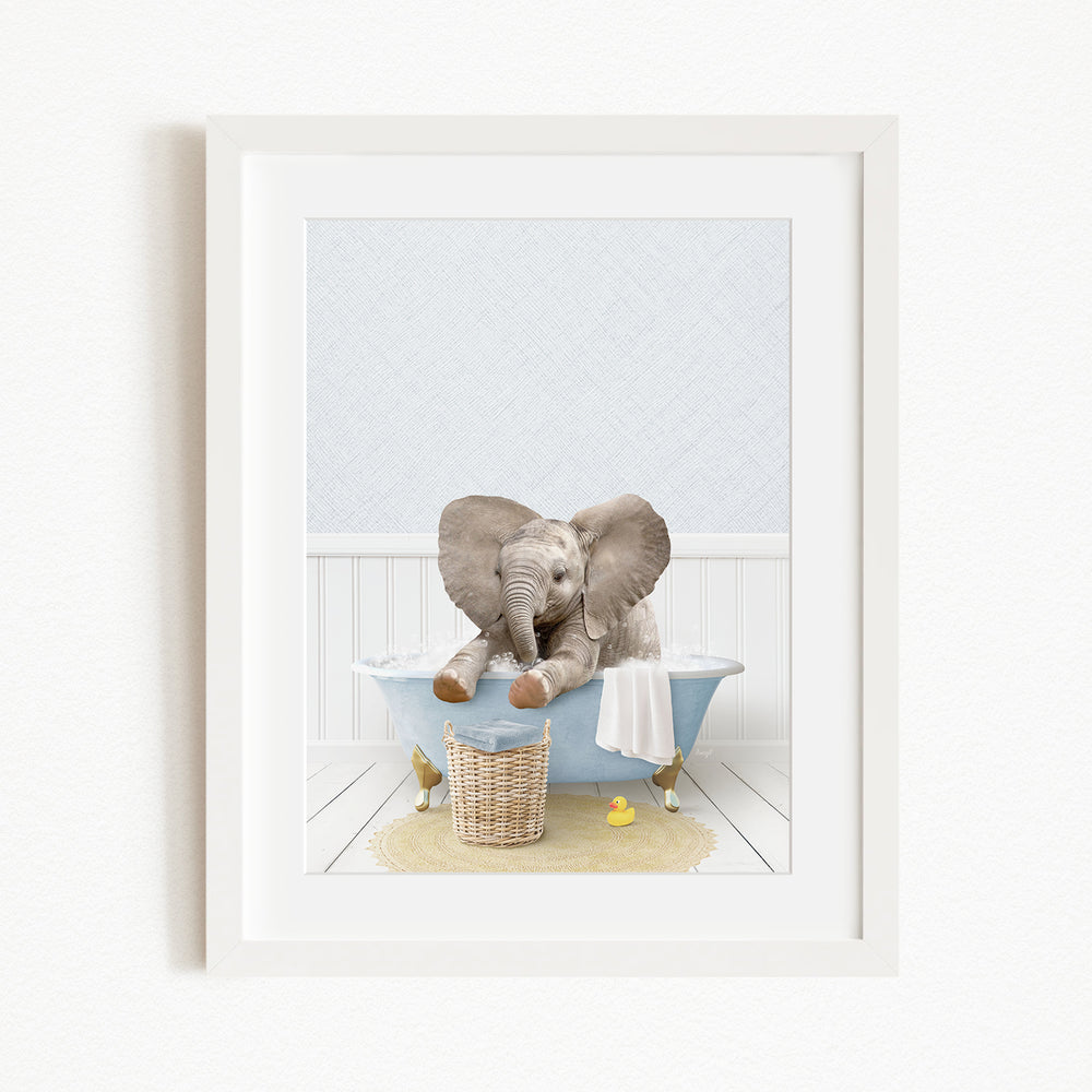 A baby elephant sitting in a blue bathtub, surrounded by rubber ducks and a basket.