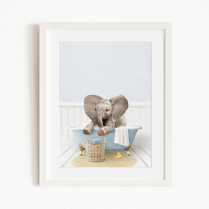 A baby elephant sitting in a blue bathtub, surrounded by rubber ducks and a basket.