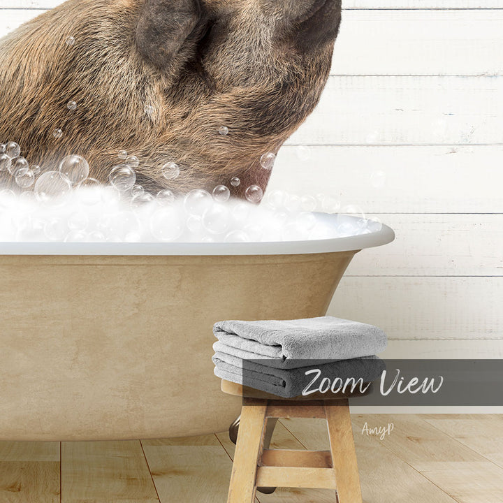 A dog is sitting in a bathtub filled with bubbles, with a towel and stool nearby.