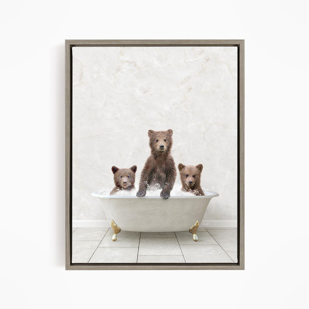 A framed image depicting three bears sitting in a white bathtub, with one bear sitting in the center and the other two bears sitting on either side.