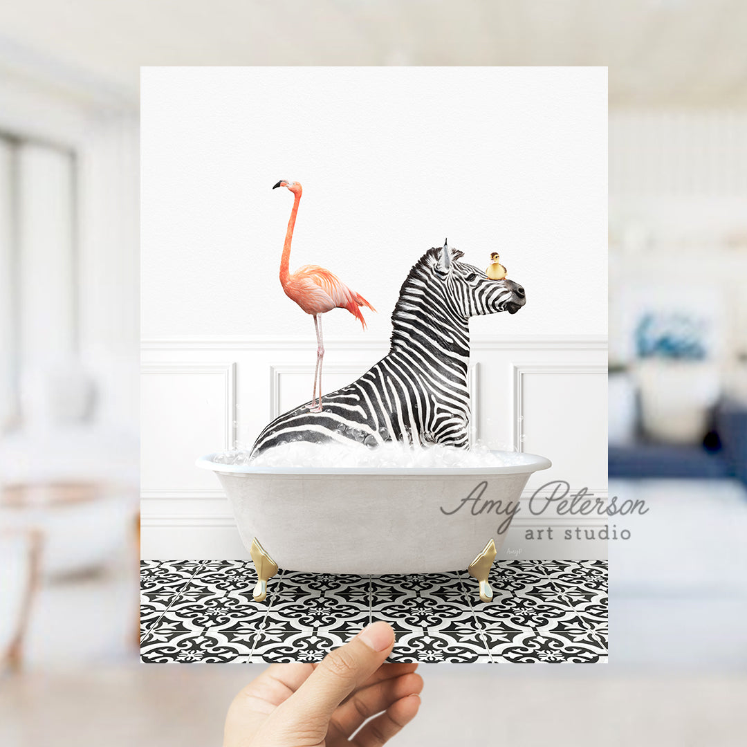 a hand holding a card with a zebra and a flamingo in a bathtub