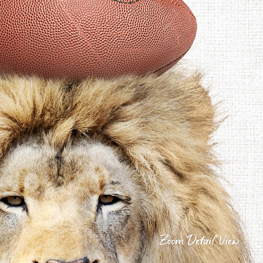 A close-up of a lion's head wearing a football helmet, with a football visible on top of the helmet.