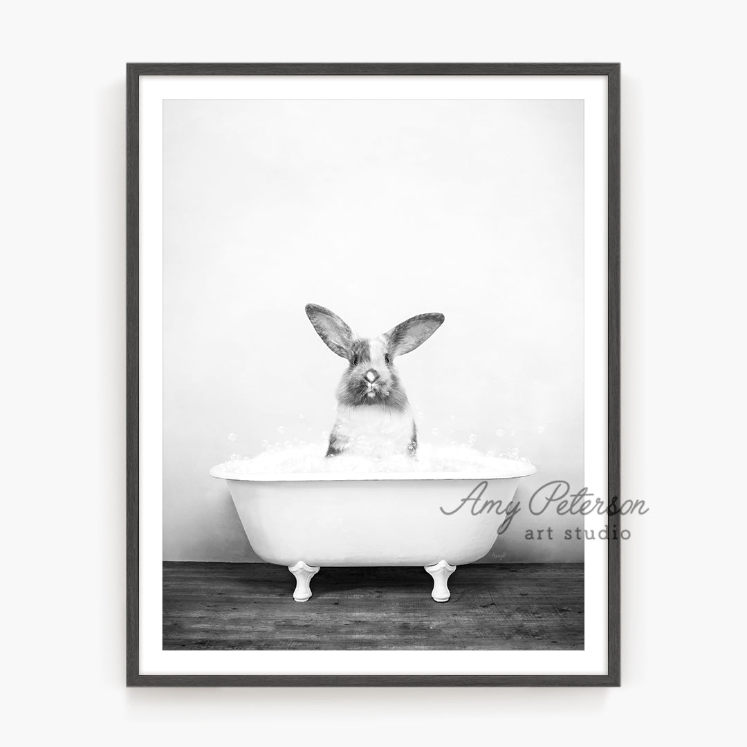 a black and white photo of a rabbit in a bathtub