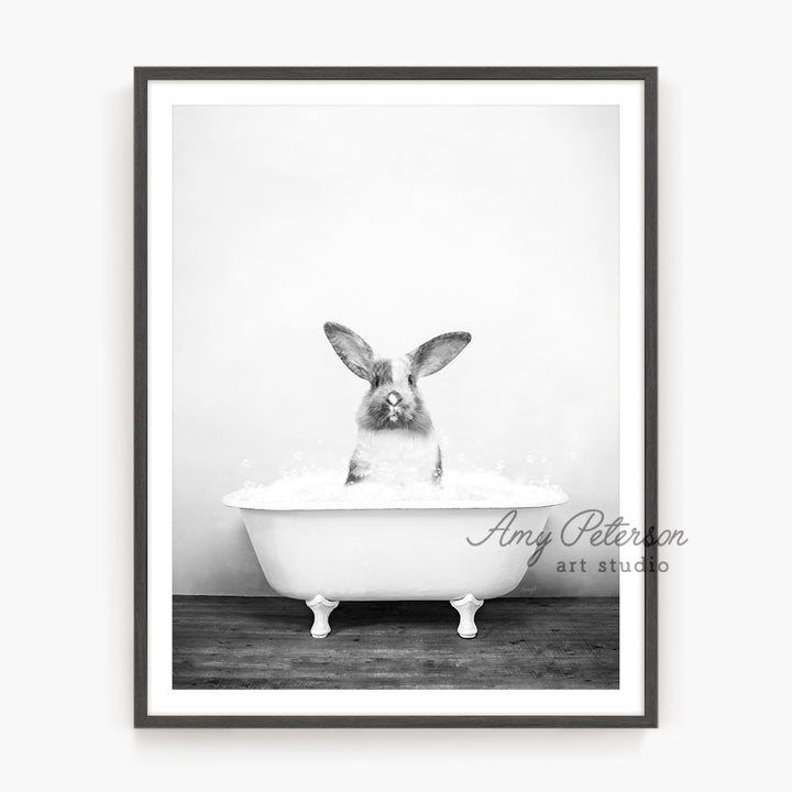 a black and white photo of a rabbit in a bathtub