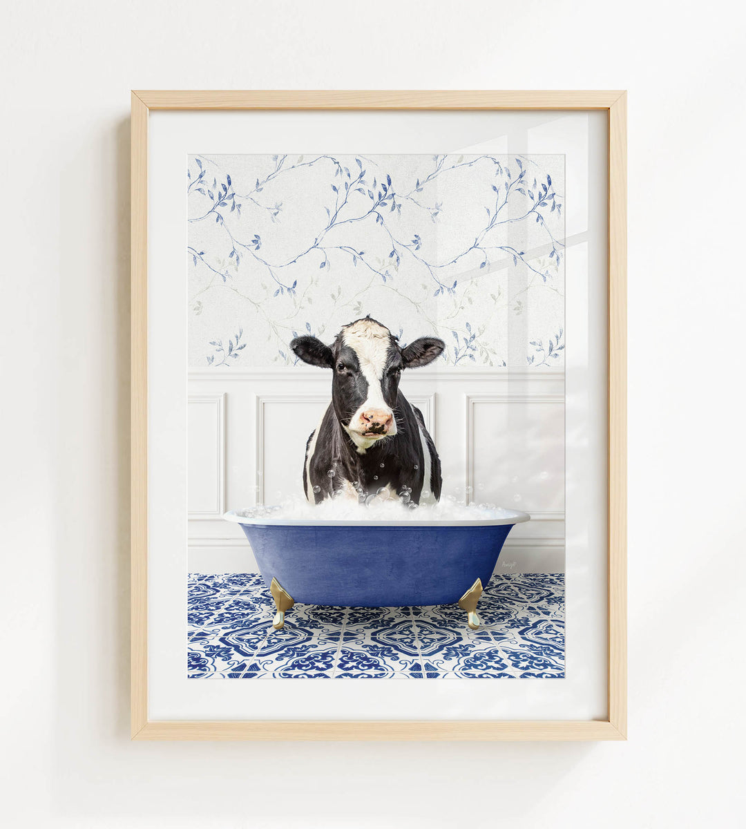 A black and white cow is sitting in a blue bathtub filled with water, surrounded by a blue and white patterned floor.
