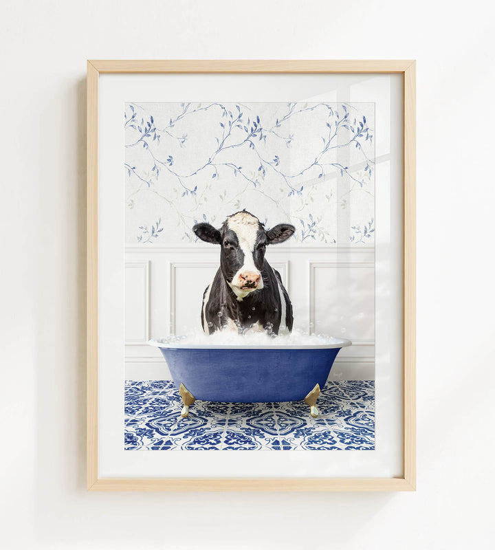 A black and white cow is sitting in a blue bathtub filled with water, surrounded by a blue and white patterned floor.