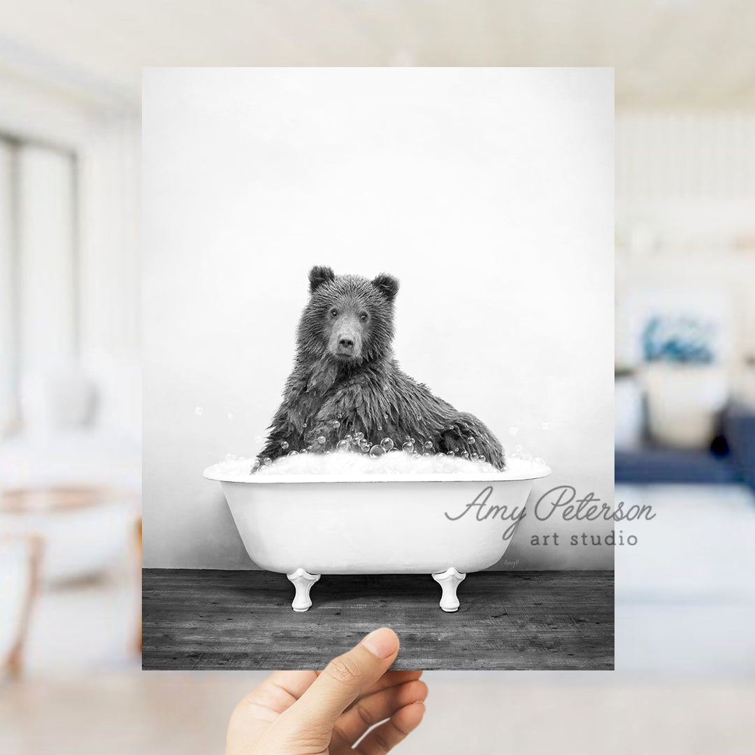 a black and white photo of a bear in a bathtub