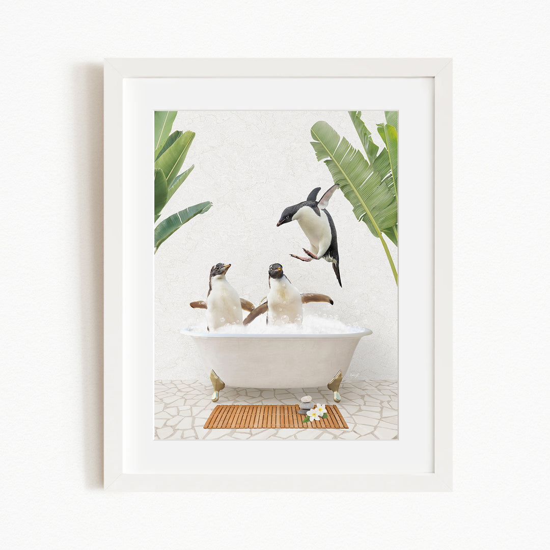 A framed image depicting three penguins sitting in a bathtub, surrounded by tropical plants and flowers.