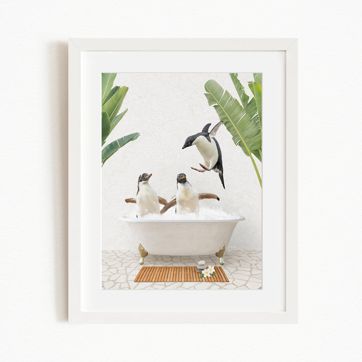 A framed image depicting three penguins sitting in a bathtub, surrounded by tropical plants and flowers.