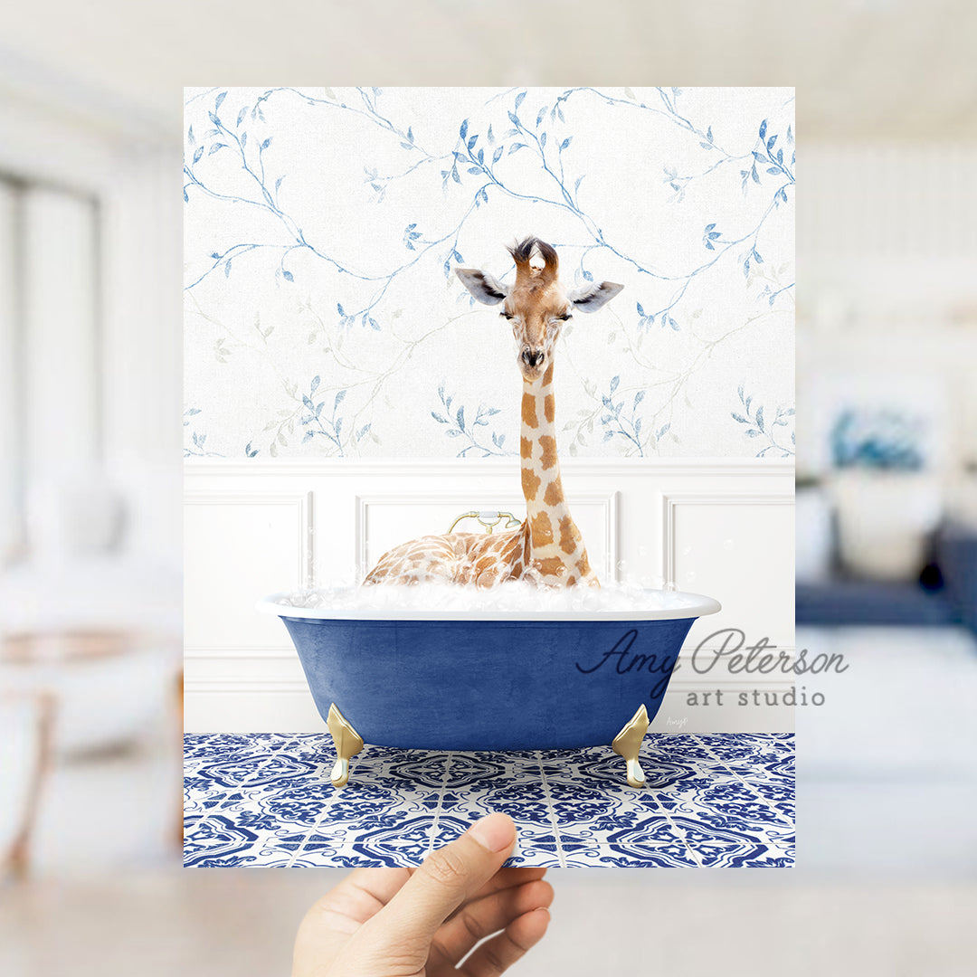 a hand holding up a card with a giraffe in a bathtub