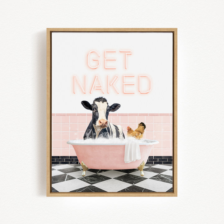 A framed image depicting a cow sitting in a pink bathtub, with a chicken nearby, and the text "GET NAKED" displayed above the scene.