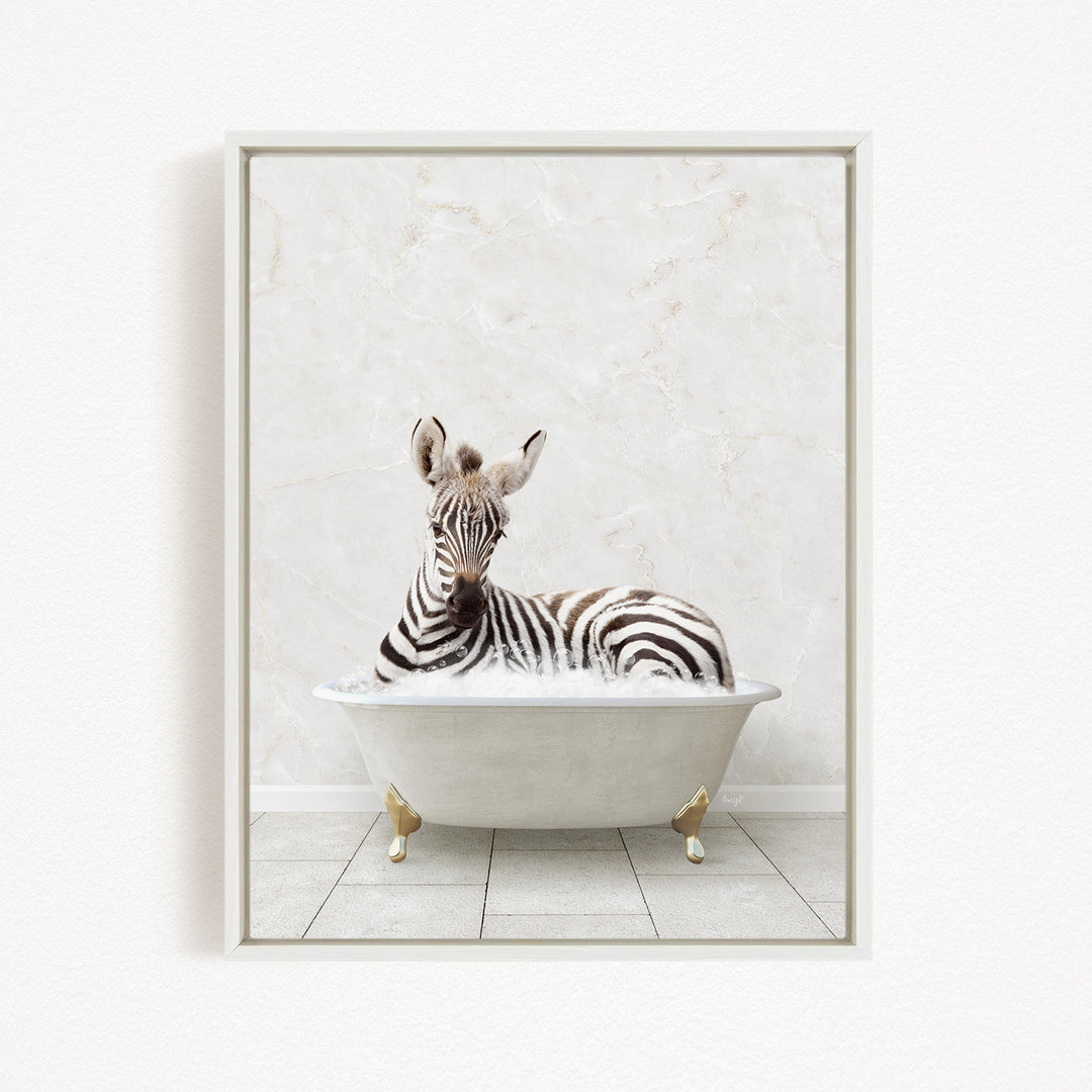 A zebra is sitting in a white bathtub, surrounded by bubbles, against a white marble wall.