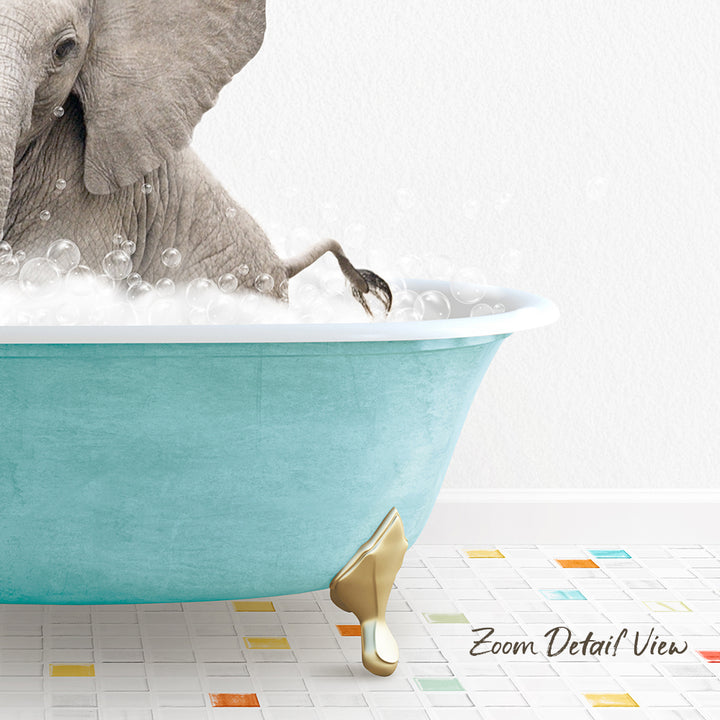 A gray elephant is sitting in a blue bathtub filled with bubbles, with its trunk submerged in the water.