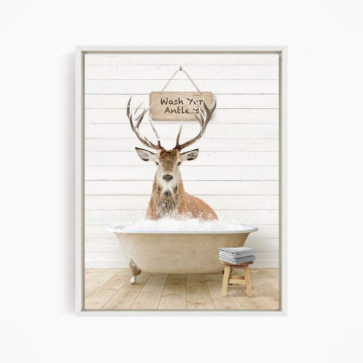 A deer with antlers is sitting in a bathtub, with a sign above it that says "Wash your antlers".
