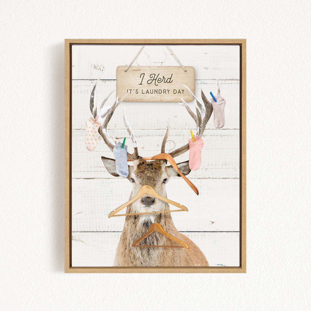 A deer with antlers wearing clothes and socks, with a sign above that says "I herd it's laundry day".