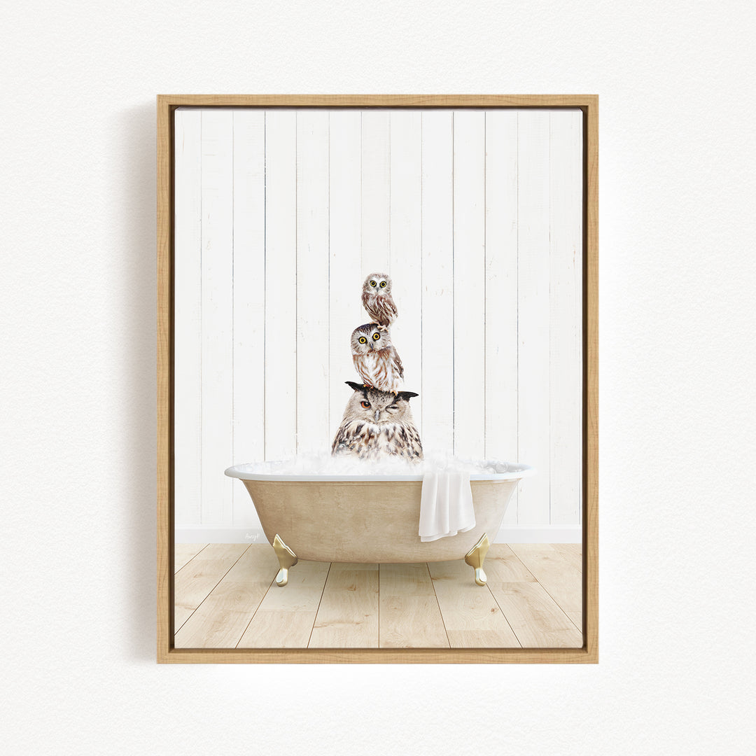 A framed image depicting a group of owls sitting in a bathtub filled with water, creating a whimsical and playful scene.