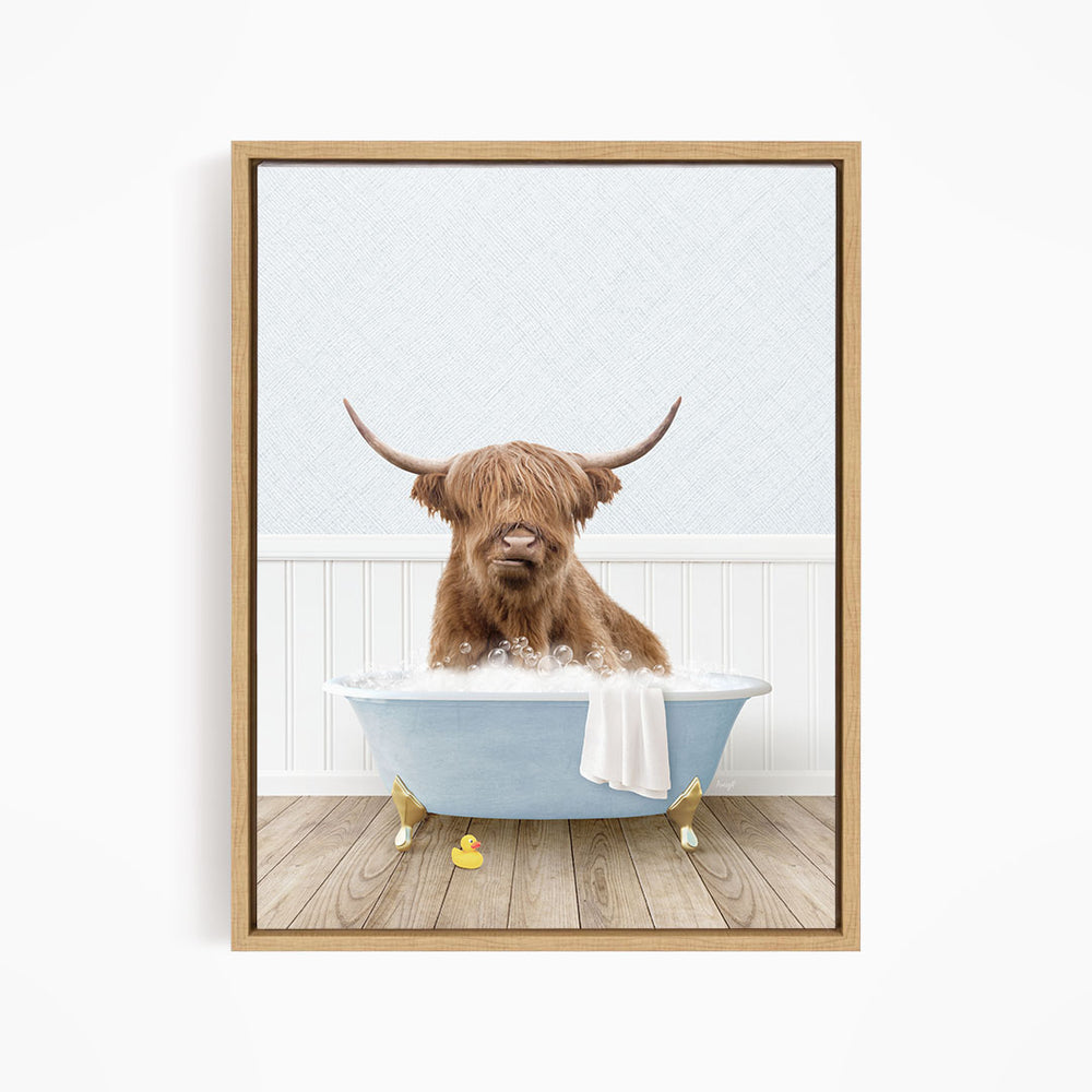 A brown cow with long horns is sitting in a blue bathtub filled with water, surrounded by rubber ducks.