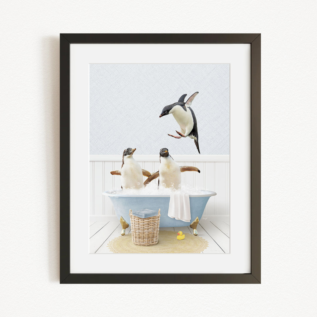 A framed image depicting two penguins sitting in a bathtub, with one penguin flying towards the other.