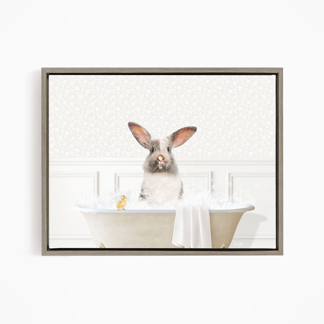 A fluffy white rabbit sits in a bathtub filled with bubbles, accompanied by a yellow rubber duck.