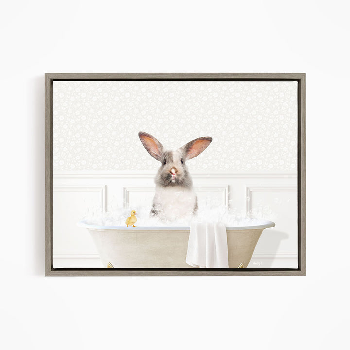 A fluffy white rabbit sits in a bathtub filled with bubbles, accompanied by a yellow rubber duck.