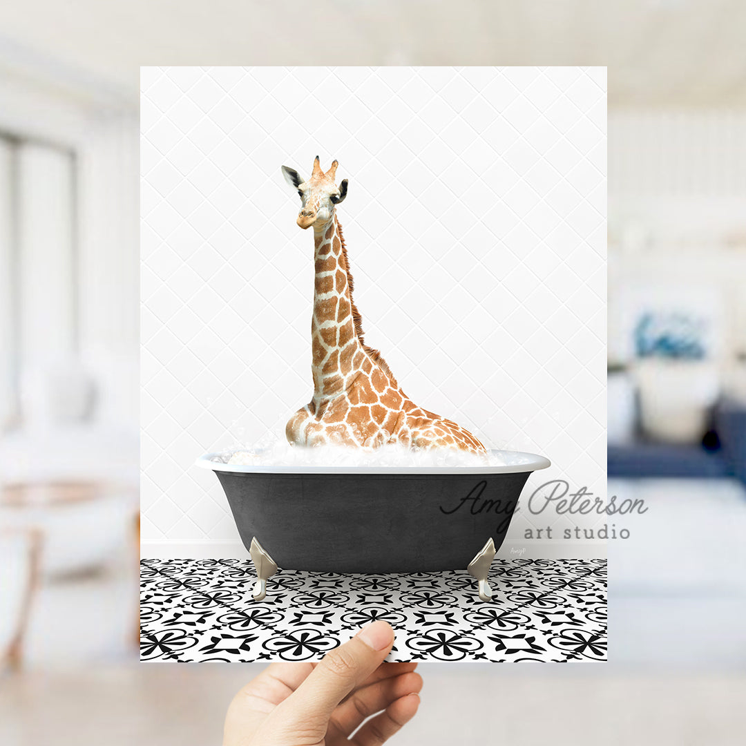 a giraffe sitting in a bathtub with a hand holding it