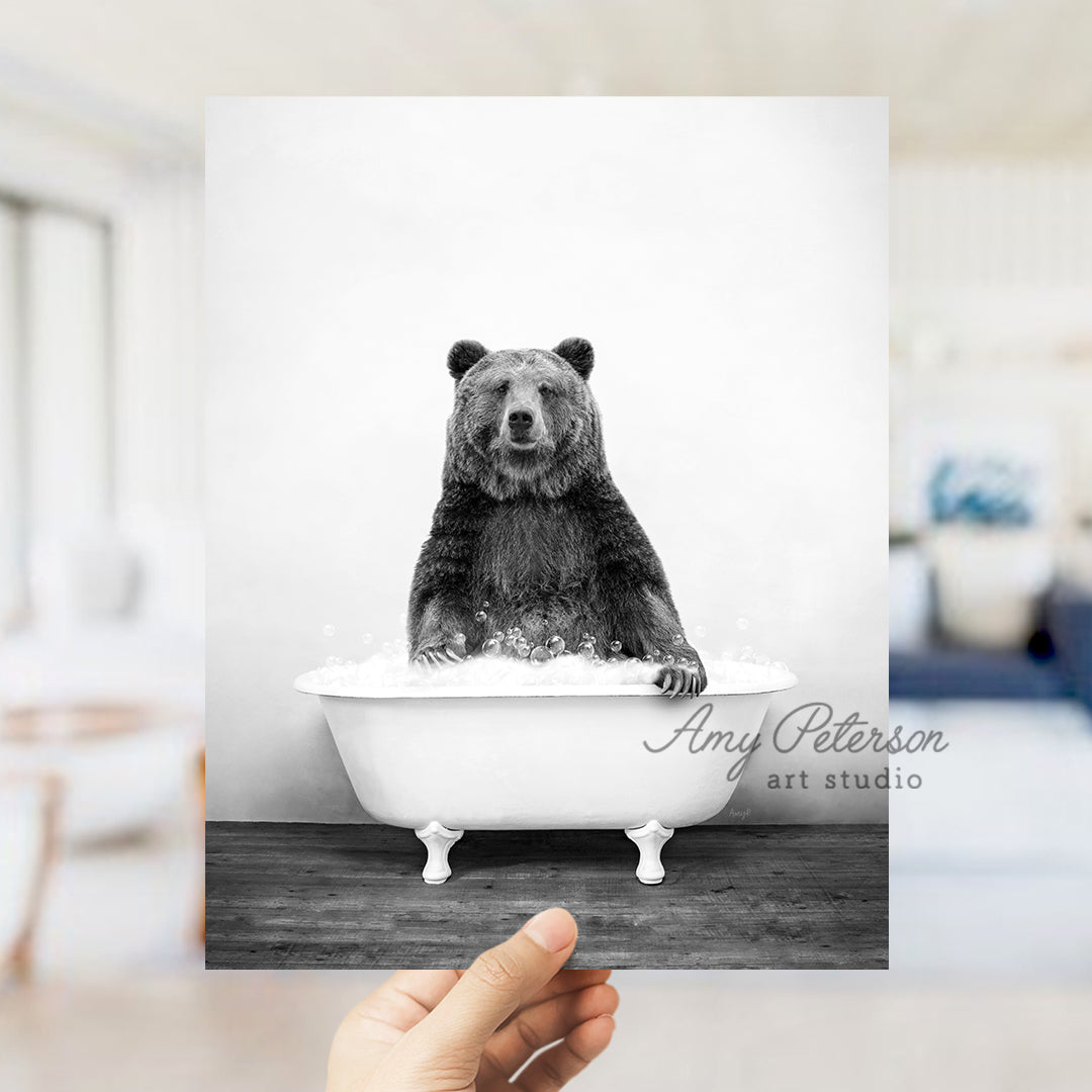 a black and white photo of a bear in a bathtub