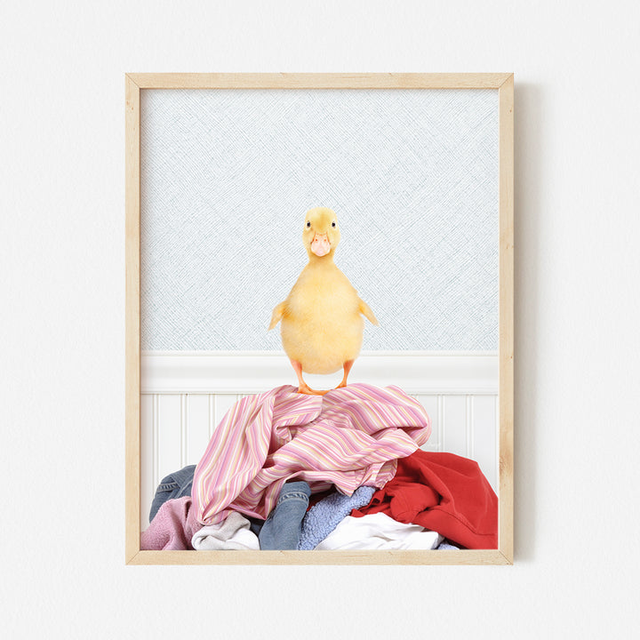 a picture of a chicken sitting on top of a pile of clothes