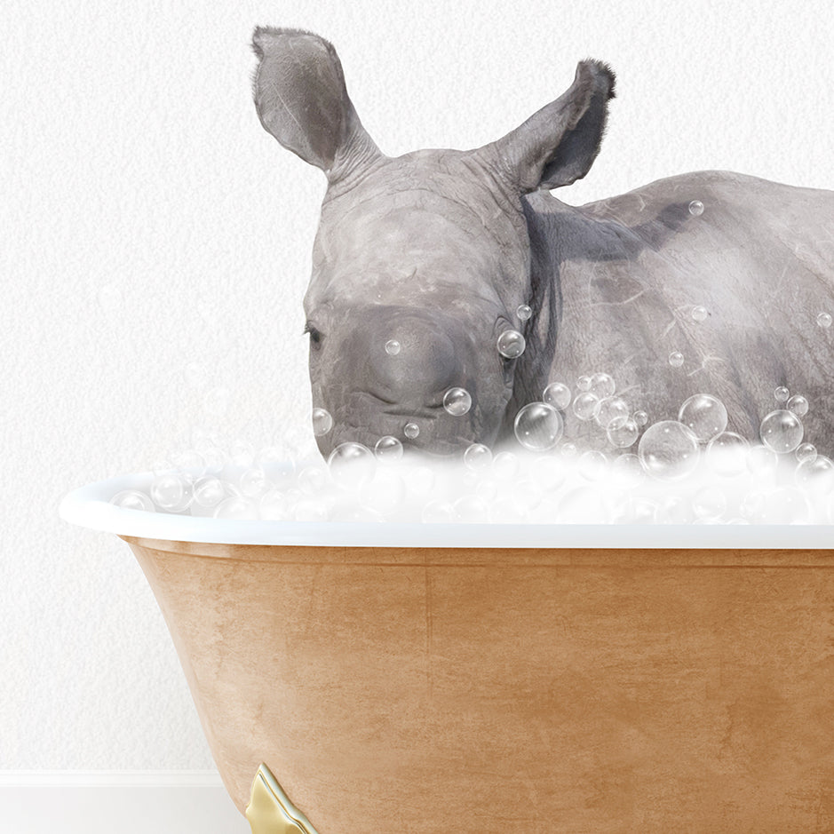 a rhino laying in a bathtub with bubbles