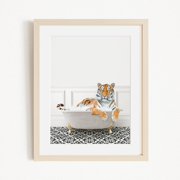 A tiger is sitting in a white bathtub, surrounded by a black and white patterned floor.