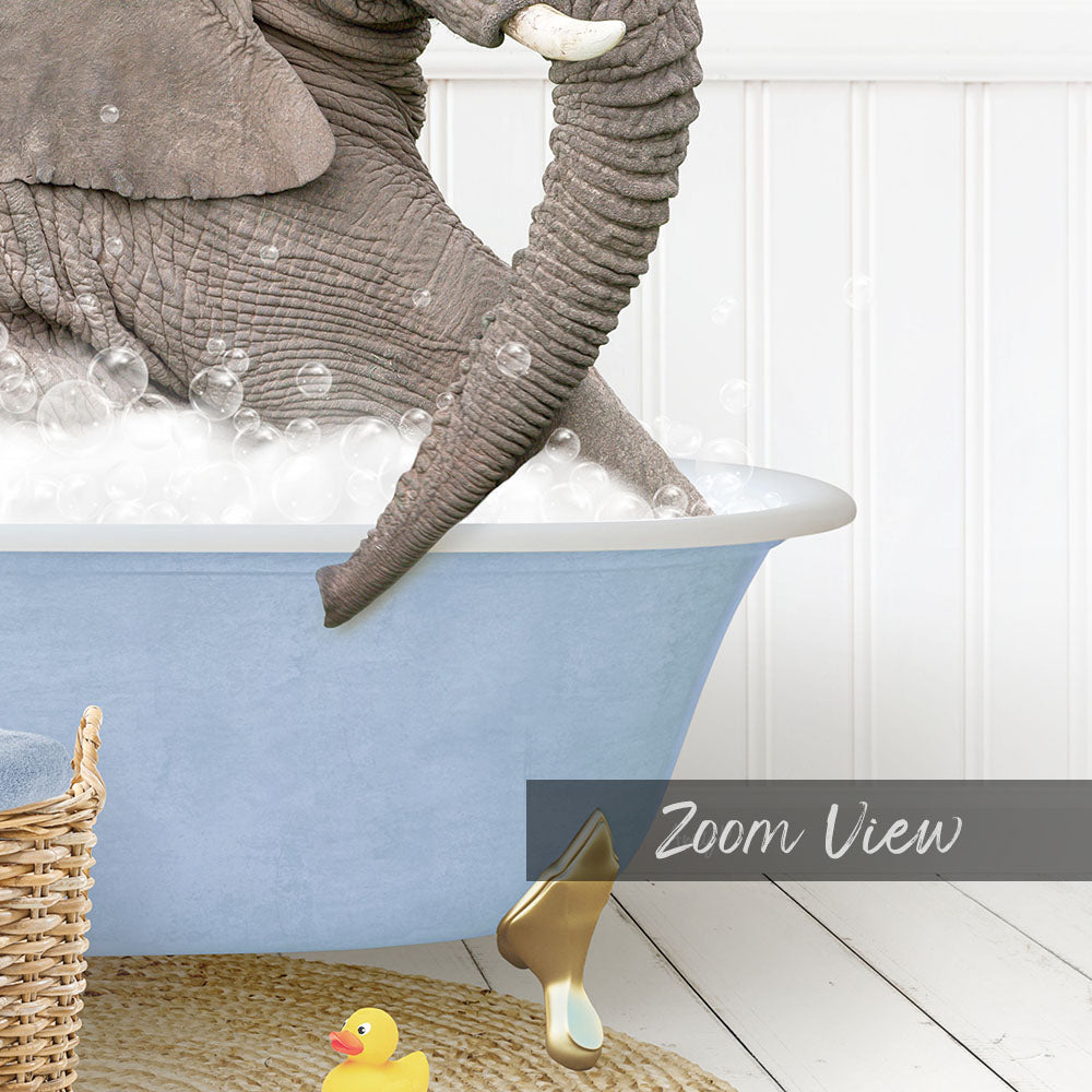 A large gray elephant is sitting in a blue bathtub filled with bubbles, surrounded by a yellow rubber duck and a woven basket.