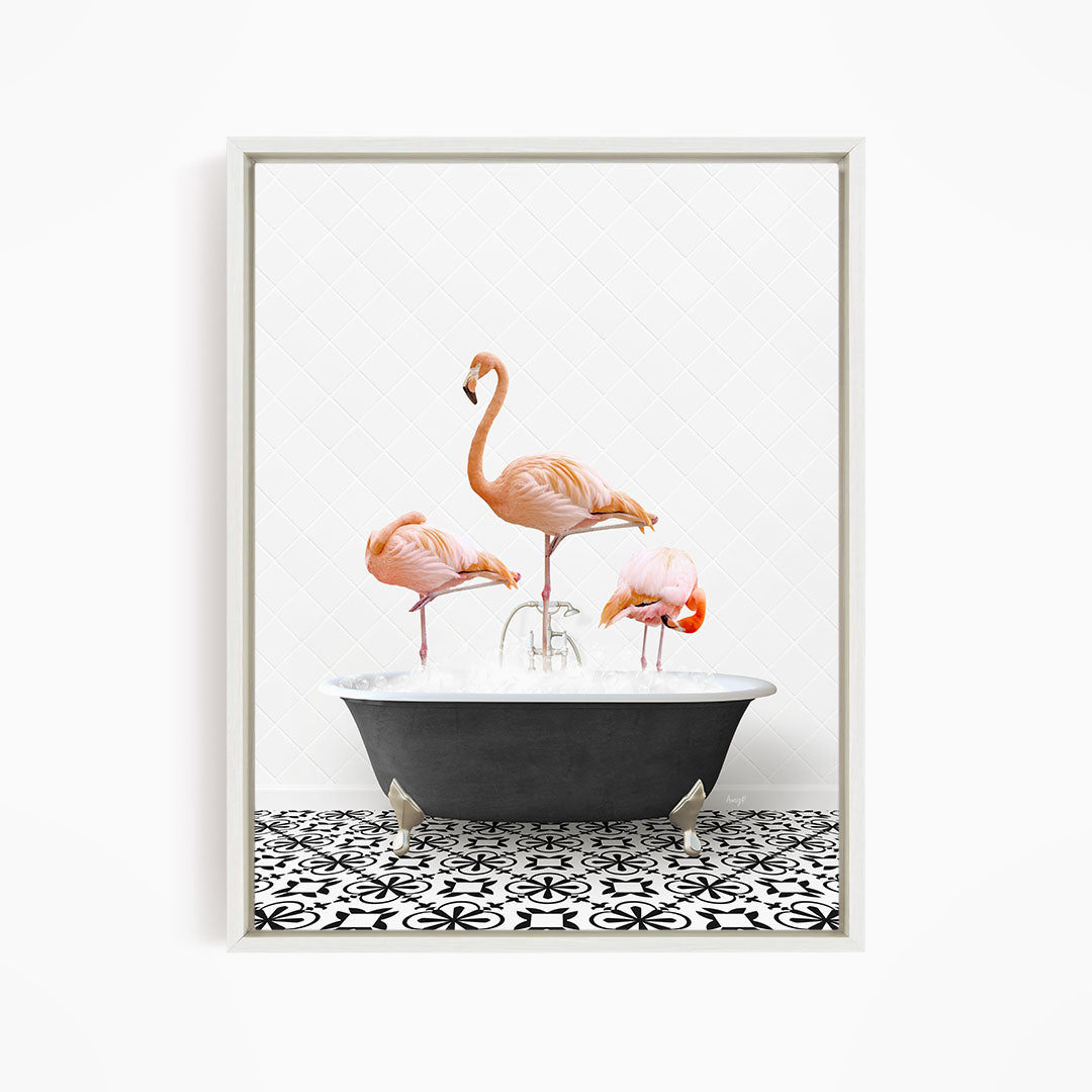 A framed image depicting three pink flamingos standing in a bathtub filled with water, creating a whimsical and playful scene.