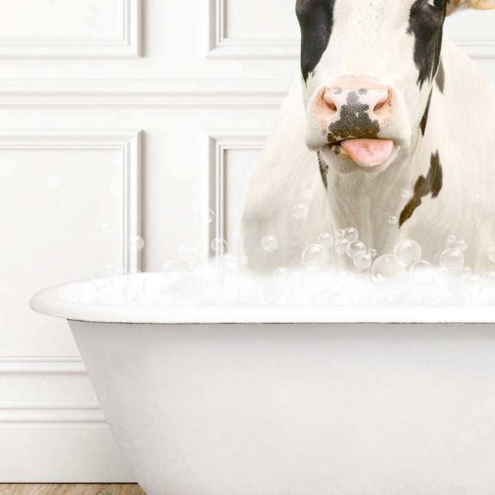 a cow sticking its tongue out in a bathtub