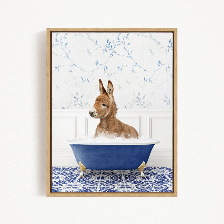 A donkey is sitting in a blue bathtub filled with water, surrounded by a patterned tile floor and a floral wallpaper background.